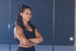© Wavebreak Media - Young biracial woman stands confidently at the gym