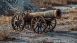 © Yusif - An antique cannon mounted on a cast iron gun carriage, set on wheels, symbolizes historical military equipment, contrasting with modern technology and weaponry.