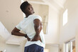 © Wavebreak Media - African american man practicing yoga, standing and stretching back at home, copy space