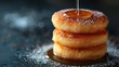 © Shanti - A tower of donuts resting on a sugary tabletop, with a tack in the center