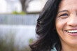 © Wavebreak Media - Half portrait of happy senior biracial woman with long black hair smiling outdoors, copy space