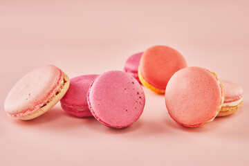 Wall Mural - Colorful macarons of different flavors on a pink background