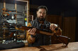 © Nomad_Soul - Salesman demonstrating professional accuracy gun assembly at counter desk