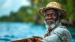 © Emiliia - A close-up portrait of a senior fisherman with a white beard wearing a straw hat and looking directly at the camera.
