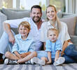© Delcio Fernandes/peopleimages.com - Portrait, family and happy kids on floor for love, care or bonding together with parents in home. Dad, mom and smile of children in living room for relax, connection or support with siblings in house