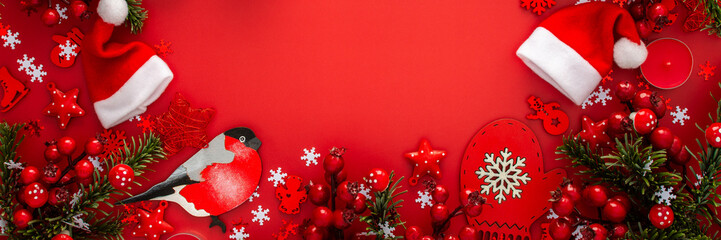 Wall Mural - Red Christmas background with fir branches and red Christmas tree toys and balls and candles, banner