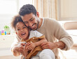 © peopleimages.com - Father, girl and playing or laughing in home with bonding, fun activity and tickling in living room. Family, man and daughter with love, security and comic game with happiness, care and parenting