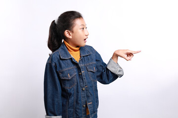 Shocked and surprised little Asian little girl open his mouth with hand and finger pointing to side, isolated on white background.