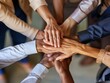 © Surachetsh - Unity and teamwork concept shown in a close up top view of business professionals putting their hands together.