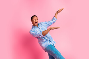 Canvas Print - Photo of cheerful positive guy dressed checkered shirt dancing emtpy space isolated pink color background