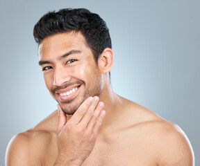 Wall Mural - portrait, skincare and smile of masculine man in studio on gray background for cosmetic wellness. be