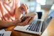 © Marko Geber - Elderly woman using a smartphone at home
