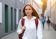 © prasanth - Beautiful Woman walking with backpack in street, going to collage, school