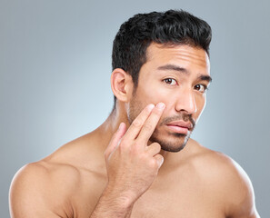 Canvas Print - Beauty, skincare and hand with man in studio, facial and wellness on white background. Dermatology, fingers and undereye cosmetics for male person, moisture and selfcare for grooming treatment