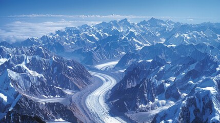 Wall Mural - A high-altitude aerial photograph of a vast mountain range, with snow-capped peaks and glacial valleys