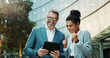 © SneakyPeakPoints/peopleimages.com - Business people, tablet and happiness outdoor with manager for planning, meeting and travel together. Ceo, woman and technology in city with partnership for research and investment deal success