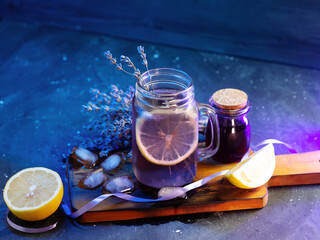 Wall Mural - cold lavender cocktail, natural lavender syrup. ice cubes . blue background