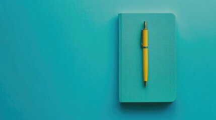 Sticker - Minimalist flat lay image of closed diary and yellow pen on turquoise background