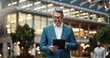 © peopleimages.com - Mature, professional and man with tablet outdoor for communication, research and typing email on website. Smile, male manager and digital for social networking, contact and pride in urban city