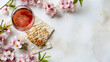 © Iqra Iltaf - Matzo wine and pink flowers apple tree for passover celebration top view flat lay