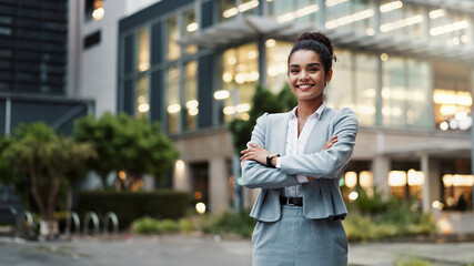 Canvas Print - Businesswoman, arms crossed or portrait by office building in city for career, smile for accounting. Female accountant, professional employee or confidence for finance job in urban with corporate