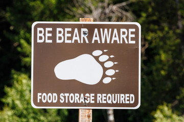 Be bear aware food storage requirement sign in Jackson Hole Wyoming because of the grizzly bear population.