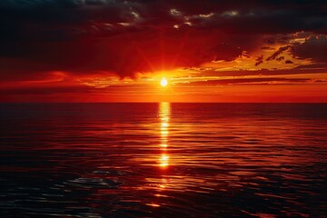 Wall Mural - A beautiful sunset over the ocean with a reflection of the sun on the water