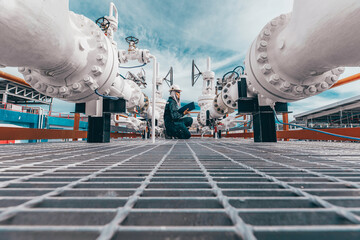 Poster - Male worker inspection at steel long pipes and pipe elbow in station oil factory during refinery valve of visual check record pipeline oil