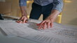 © stockbusters - Engineer hands drawing plan building on office table close up. Focused architect