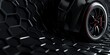© zakiroff - High tech black car wheel on hexagonal textured surface futuristic design automotive technology concept