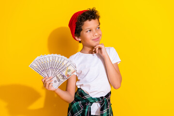 Poster - Photo of adorable little boy money fan look interested empty space dressed stylish white garment isolated on yellow color background