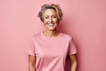 Poster - Portrait of a grinning woman in her 40s dressed in a casual t-shirt over solid pastel color wall