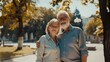 © The Little Hut - Happy smiling senior couple family hugging while walking in summer city park enjoying retirement and spending time together in nature Romance love care and elderly people relationship  : Generative AI