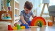 © The Little Hut - Male kid playing rainbow Montessori wooden natural material early development plaything sitting on floor at home Cute baby child building labyrinth with colored curved arch ecology cub : Generative AI