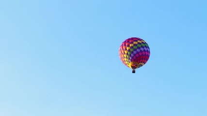 Wall Mural - Colorful hot air balloon flying in the blue sky. Rainbow colored balloons in the sky at sunset. Summer landscape. 
