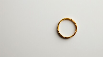 A minimalist white background with a single, elegant gold ring placed delicately in the center