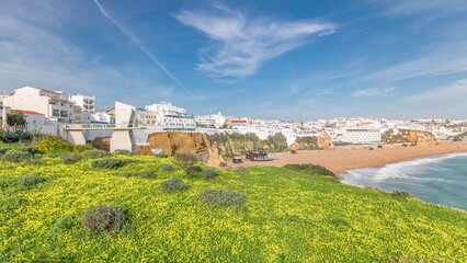 Wall Mural - Wide sandy beach and Atlantic ocean in city of Albufeira timelapse. Algarve, Portugal