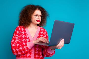 Wall Mural - Photo of serious busy woman wear red cardigan spectacles reading modern device empty space isolated blue color background