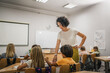© Miljan Živković - Mature teacher walk and wait to her students finish exam