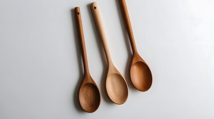 Concept photo of top view of wooden spoons on white background with space for text