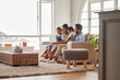 © Alex Shared/peopleimages.com - Family, sofa and laptop in home living room for video call, conversation and support with parents. Love, people together and couch with communication and tech, lounge and smile on holiday in Florida