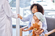 © Alex Shared/peopleimages.com - Mother, child and doctor with handshake in hospital for thank you, support and consulting. Healthcare, happy and mom, girl and paediatrician for cancer treatment, medical success and chemotherapy