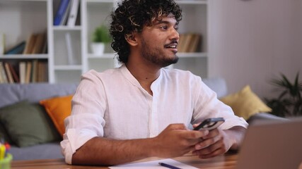 positive young indian man student relaxing at home take a break from study or work typing browsing p