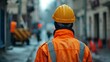 © Ali - Construction worker with yellow helmet and reflective jacket standing on the street