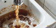 © IndigoElf - Dirty brown water running into a sink from a tap. Old dirty plumbing, hard water