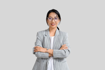 Sticker - Happy young Asian businesswoman in eyeglasses on grey background