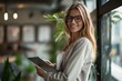 © Damian - Portrait of happy businesswoman with touchpad in office