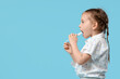 © Pixel-Shot - Happy cute little girl with toothbrush on blue background