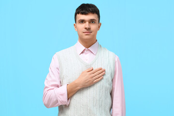 Wall Mural - Young deaf mute man using sign language on blue background