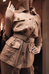 Poster - Female mannequin dressed in a stylish beige pants and jacket.